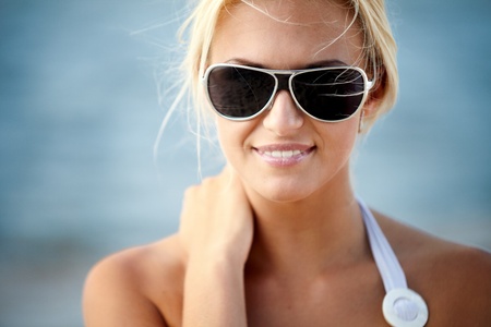 Sexy blond girl posing on a beachの写真素材
