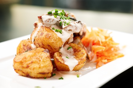 Baked pork with mushrooms and cheese, herb potatoesの写真素材