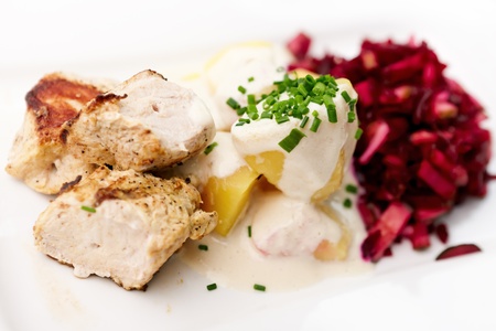 Grilled turkey with boiled potatoes and beet-cucumber saladの写真素材