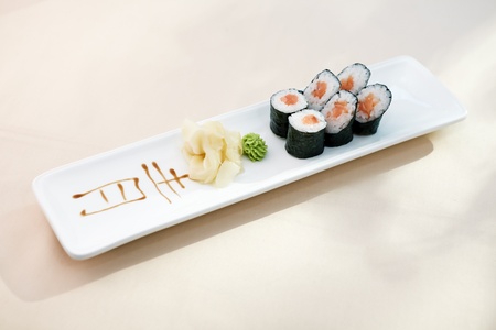 Tuna maki with wasabi and ginger on a plateの写真素材
