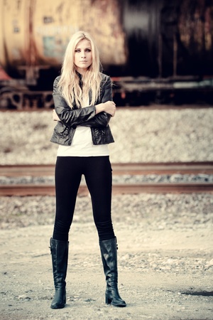Young woman standing near a trainの写真素材