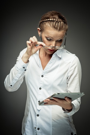 Young business woman exploring tablet computerの写真素材