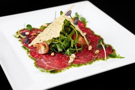 Beef carpaccio on black backgroundの写真素材