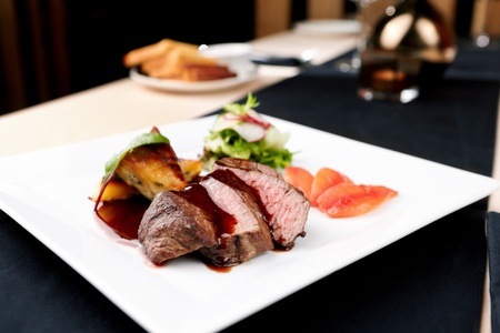Beef fillet with potato gratin and fresh saladの写真素材