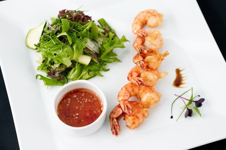 Tempura shrimps with garlic and chilli on a plateの写真素材