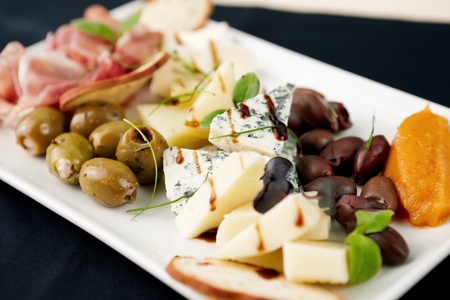 Snacks selection for wines (Parma ham, olives, cheese)の写真素材