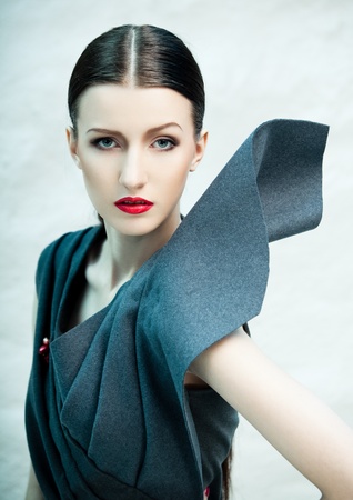 Fashion portrait of beautiful female model covered with blue lightの写真素材