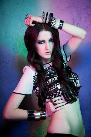 Fashion portrait of beautiful female model in a mixed blue and red lightの写真素材