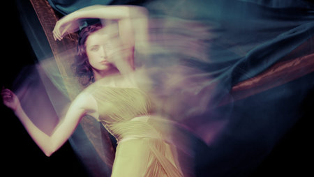 Fashion portrait of brunette lady in long dress shot in mixed light techniqueの写真素材