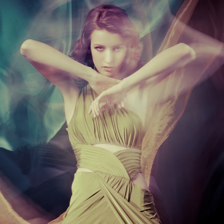 Fashion portrait of brunette lady in long dress shot in mixed light techniqueの写真素材