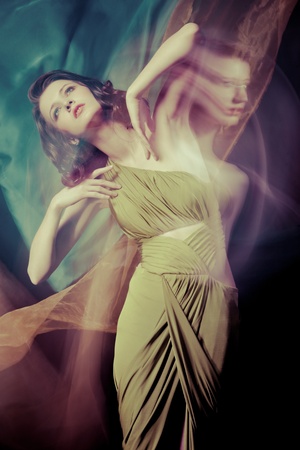 Fashion portrait of brunette lady in long dress shot in mixed light techniqueの写真素材