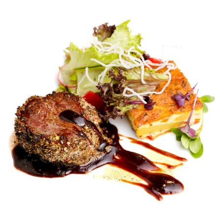Beef fillet with potato gratin and fresh saladの写真素材