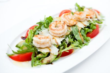 Rocket salad with fried shrimps and avocadoの写真素材