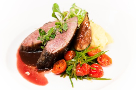 Glazed duck fillet, mashed potatoes seasoned with truffle oil, fig and aniseed sauceの写真素材