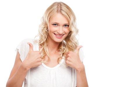 Young cute smiling girl showing thumbs up isolated on whiteの写真素材