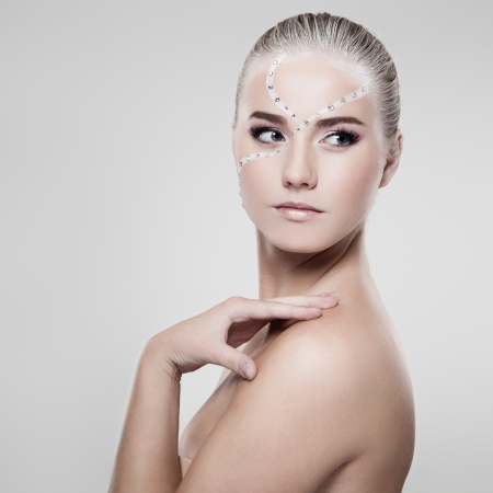 Portrait of a model with fashionable makeup on gray backgroundの写真素材