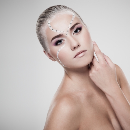 Portrait of a model with fashionable makeup on gray backgroundの写真素材