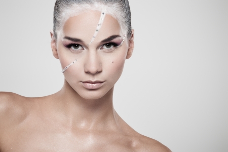 Portrait of a model with fashionable makeup on gray backgroundの写真素材