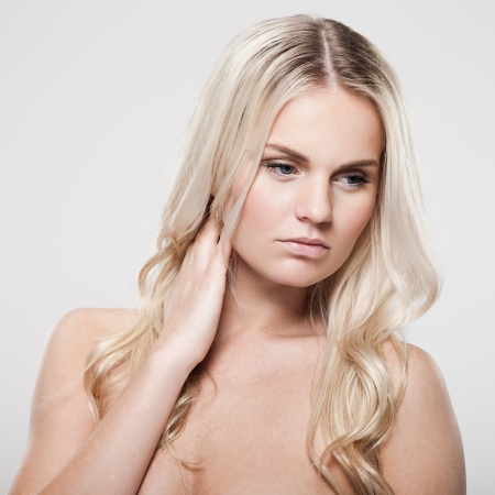 Portrait of a beautiful female model on gray backgroundの写真素材