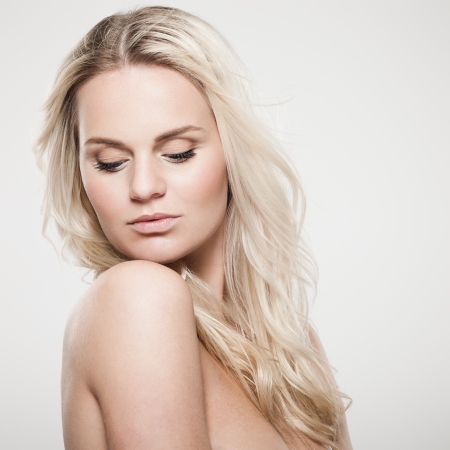 Portrait of a beautiful female model on gray backgroundの写真素材