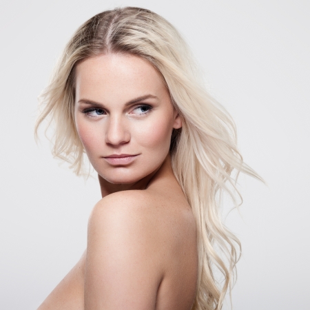 Portrait of a beautiful female model on gray backgroundの写真素材