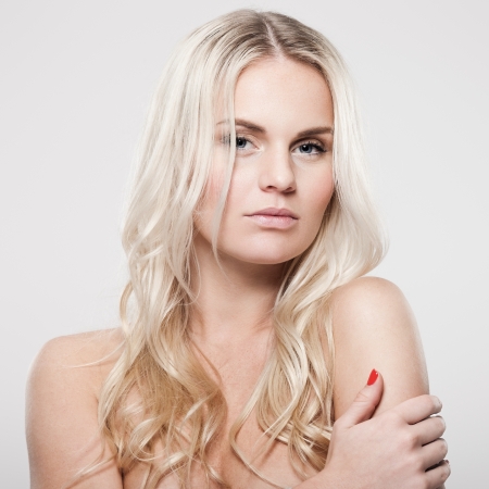Portrait of a beautiful female model on gray backgroundの写真素材