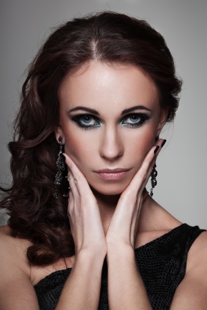 Closeup portrait of a serious lady with smoky eye makeupの写真素材