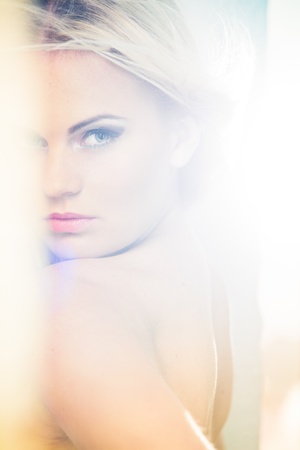Portrait of a beautiful female model in bleached lightの写真素材
