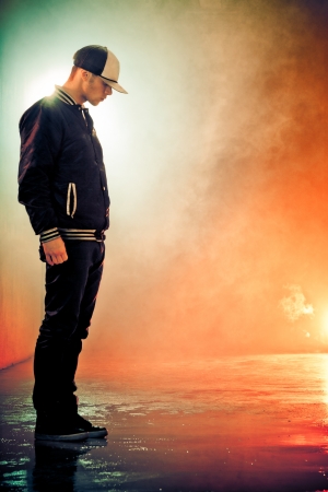 Teenage brakedancer boy standing in a smokeの写真素材