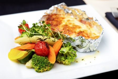 Baked in foil salmon with vegetablesの写真素材