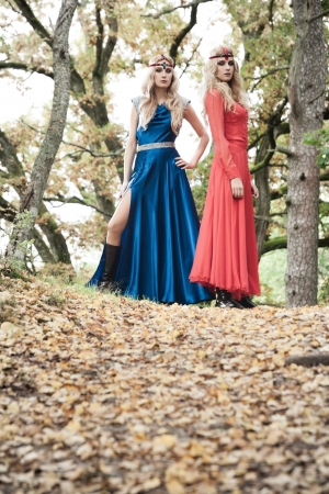 Two fashionable women posing in autumn forestの写真素材