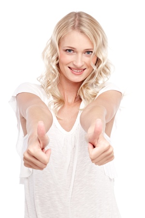Young cute smiling girl showing thumbs up isolated on whiteの写真素材