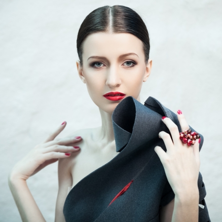 Fashion portrait of beautiful female model covered with blue lightの写真素材