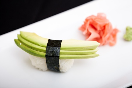 Avocado sushi served on a plate with ginger and wasabiの写真素材