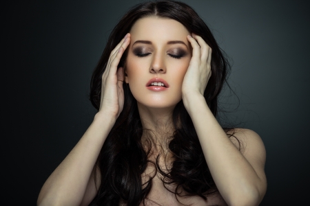 Portrait of beautiful female model on gray backgroundの写真素材