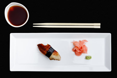 Eel sushi served on a plate with ginger and wasabiの写真素材