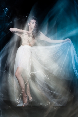 Fashion portrait of brunette lady in long dress shot in mixed light techniqueの写真素材