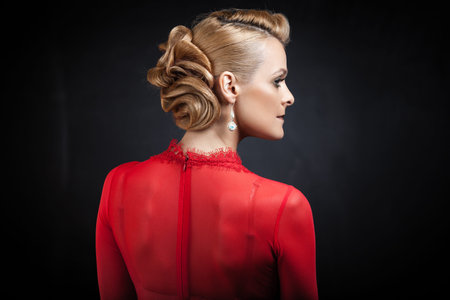 Sexy blond woman posing on dark background