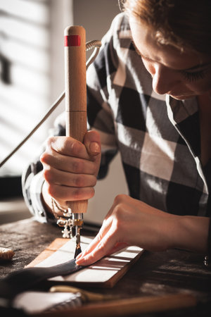 Leather handbag craftsman at work in a workshop