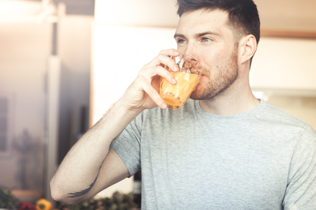 man drinking orange juiceの写真素材