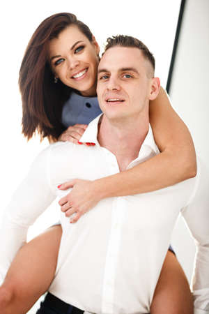 Relaxed young couple having a good times at home in bright living roomの写真素材