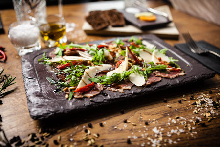 Beef carpaccio served on a board in restaurant