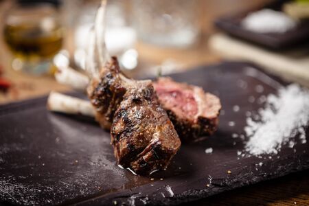 Grilled lamb chops served with a branch of rosemaryの写真素材