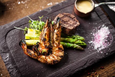 Tasting menu. Beef steak and grilled tiger prawns.の写真素材