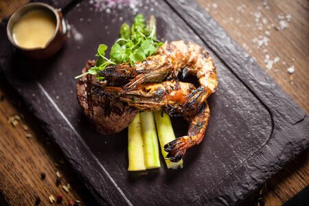 Tasting menu. Beef steak and grilled tiger prawns.の写真素材