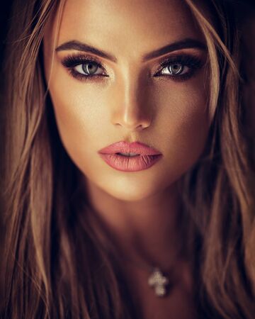 portrait of a beautiful lady with glamorous makeup on greyの写真素材