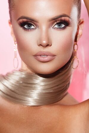 portrait of a beautiful lady with glamorous makeup on greyの写真素材