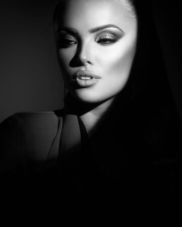 stylish lady in a spot of light in monochromeの写真素材