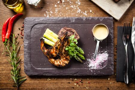Tasting menu. Beef steak and grilled tiger prawns.の写真素材
