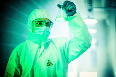 corona virus concept. male doctor reviewing glass flaskの写真素材